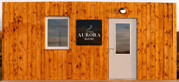 The font of the facilities building at Aurora Igloo with a sign on it.