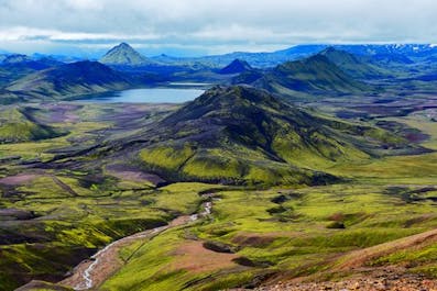 Striking green mountains and a distant lake in the Icelandic Highlands.
