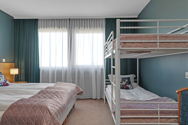 The family rooms at Hotel Kvika are comfortable and practical, with a double bed and bunk beds.