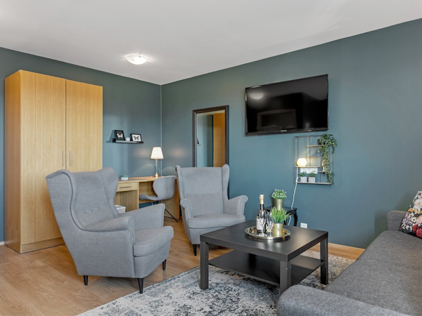 Relax in comfortable chairs and enjoy wine or champagne in your room at Hotel Kvika.