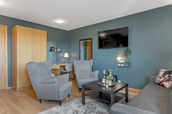 Relax in comfortable chairs and enjoy wine or champagne in your room at Hotel Kvika.