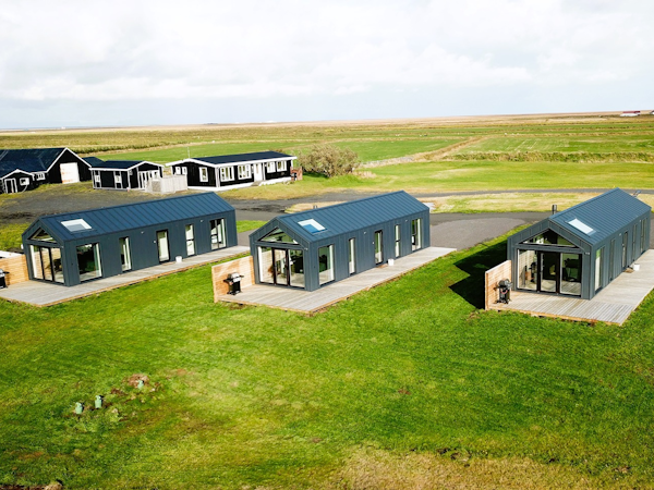 Three houses of the luxurious Arctic Exclusive Ranch sit in a row.