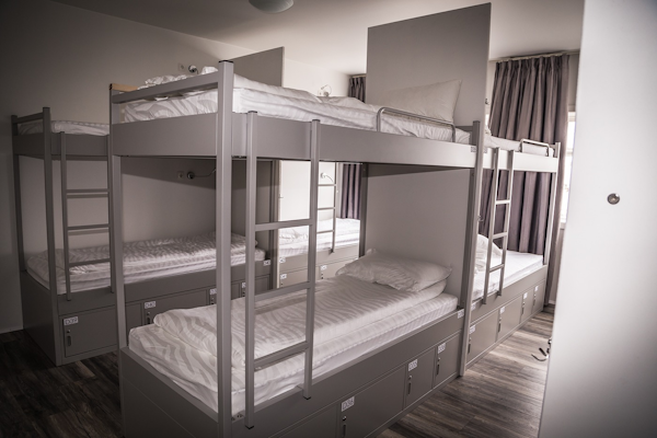 Guests unwind in clean and comfy bunk beds, creating a home-away-from-home ambiance in the dormitories.