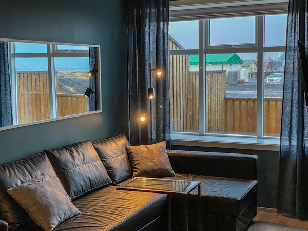 Relax by the large window with a view from the comfy sofa, offering the perfect spot to unwind and soak in the scenery.