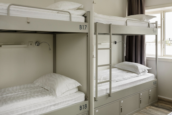 Experience a restful night's sleep in the cozy bunk beds, promising comfort and relaxation in the dormitory rooms.