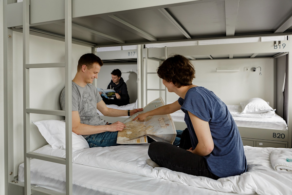 Guests unwind in the dormitory room, enjoying the camaraderie and comfort of shared accommodations during their stay.