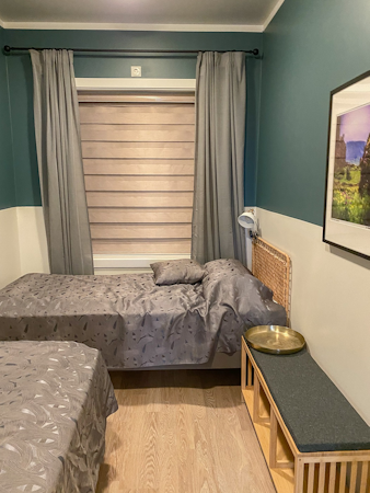 Experience flexibility and comfort in the Deluxe Two-Bedroom Apartment, featuring a room with two single beds.