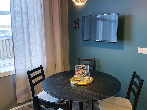 Gather around the round dining table in the deluxe studio apartment.