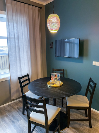 Gather around the round dining table in the deluxe studio apartment.