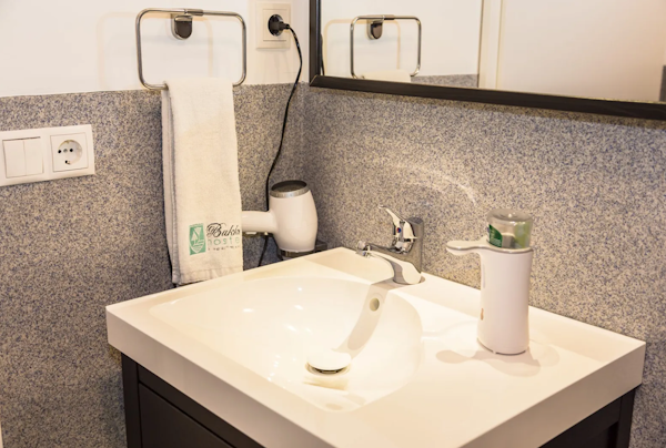 Enjoy the well-equipped sink area, featuring a hairdryer for your convenience.
