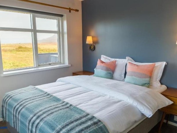 Stay in a comfortable room with stunning countryside vistas at Soti Lodge in North Iceland.