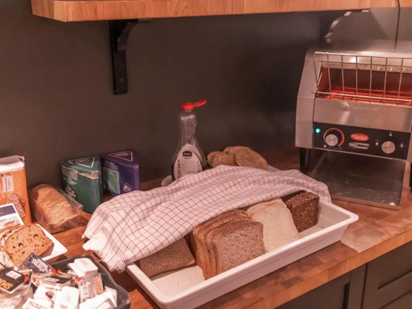 A selection of breads, spreads, and a toaster at Hotel Kvika.