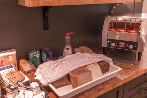 A selection of breads, spreads, and a toaster at Hotel Kvika.