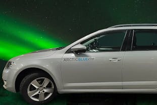 A comfortable vehicle for airport transfers with the northern lights in the background.