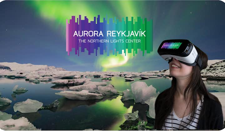 A woman wearing a VR headset looks upwards at Aurora Reykjavik.