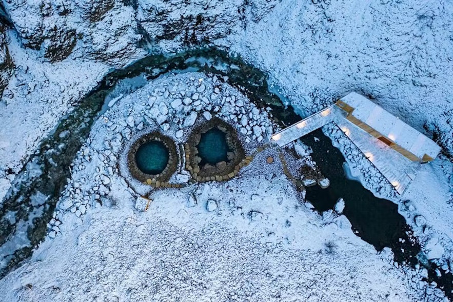 A bird's-eye view of the Husafell Canyon Baths in winter.