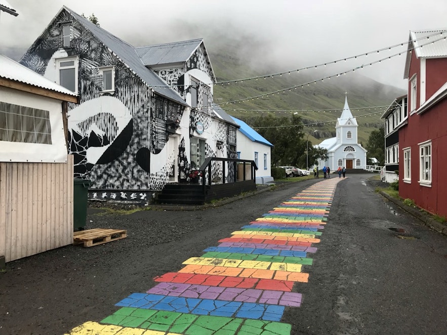 A rainbow colored road leads to Seydisfjordur.
