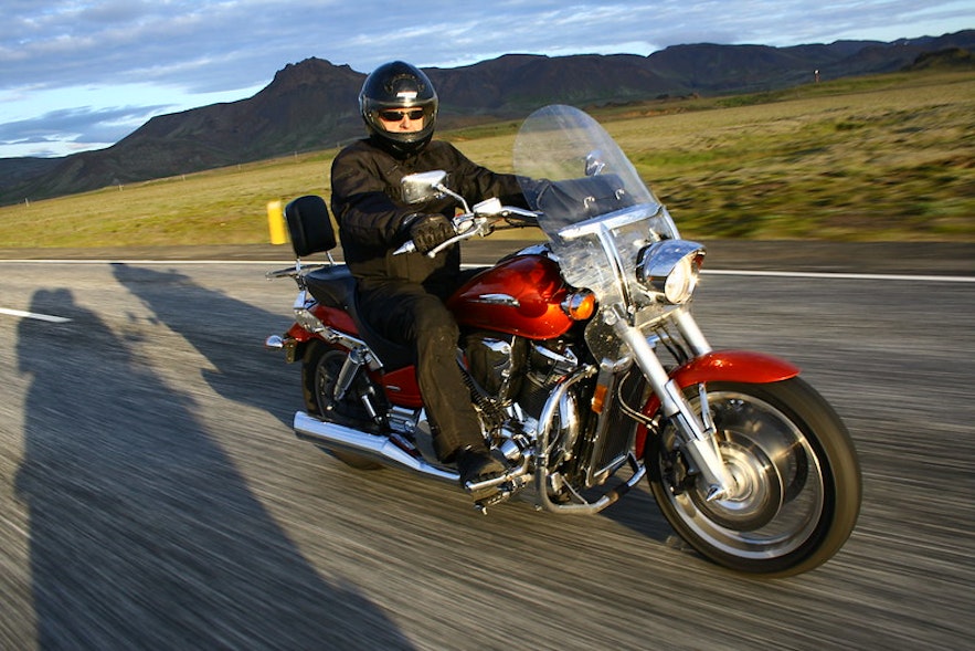 A biker rides his motorcycle through Iceland.