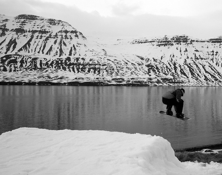 A snowboarder jumps in a makeshift ski spot on the Seydisfjordur fjord in East Iceland.