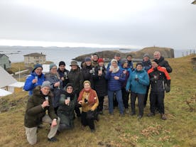 A group of travelers enjoying a glass of drinks after exploring Stykkisholmur in Iceland.