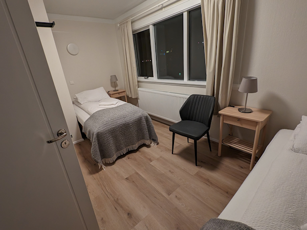 A room at the Stykkisholmur Inn with a twin bed setup.