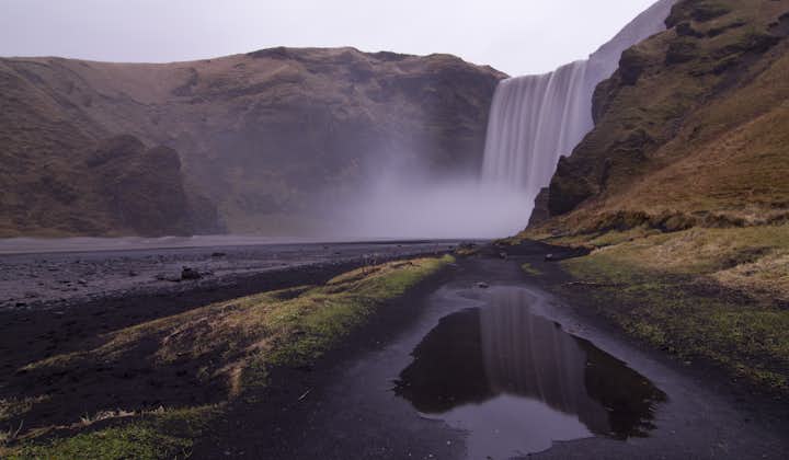 Even on a moody day, the South Coast's Skógafoss waterfall is visually impressive.