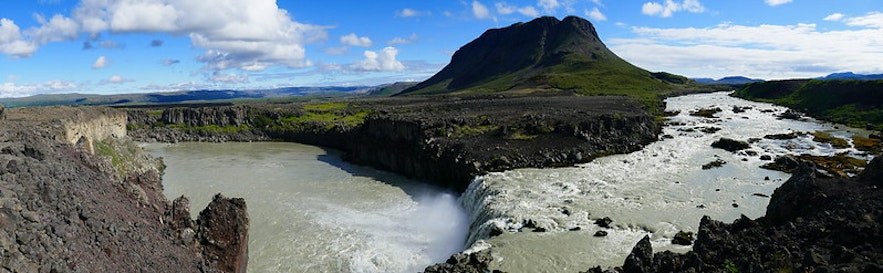 A panoramic photo of the Thjofafoss waterfall and Burfell mountain in South Iceland.