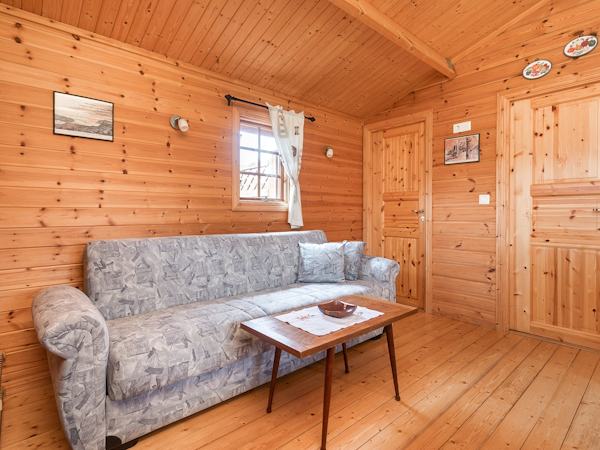 The cottages at the Sireksstadir holiday farm have living areas with sofas and tables.