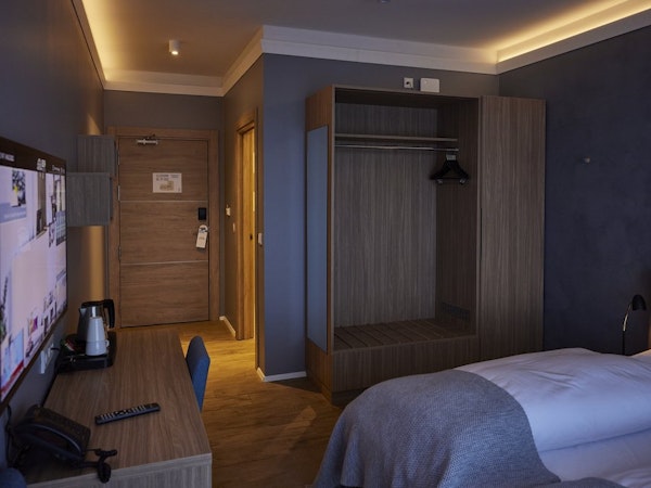 The rooms at Hotel Vesturland have practical amenities, such as a closet, desk, chair, and coffee maker.