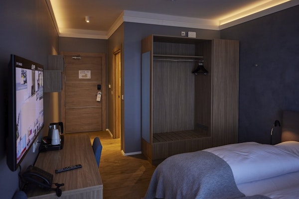 The rooms at Hotel Vesturland have practical amenities, such as a closet, desk, chair, and coffee maker.