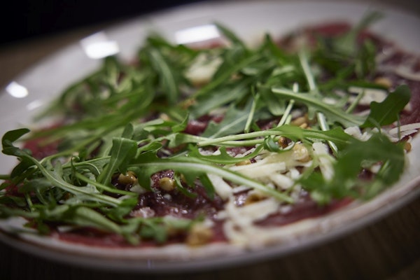 A delicious pizza topped with fresh greens at Hotel Vesturland's restaurant.