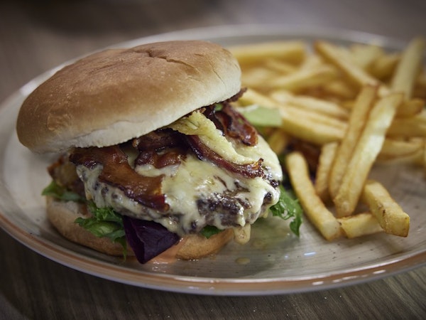 Order a delicious burger and chips at the restaurant in Hotel Vesturland.