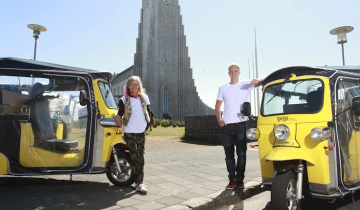 Guests strike a pose with their tuk-tuks and the Hallgrimskirkja church in the background.