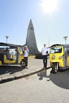 Guests strike a pose with their tuk-tuks and the Hallgrimskirkja church in the background.