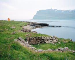 The rugged landscape meets the calming waters in Brimnes in East Iceland.