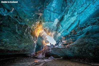 The sun adds more colours to the beautiful blue ice cave in Vatnajökull National Park
