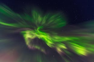 A swirl of northern lights illuminating the skies in Iceland.