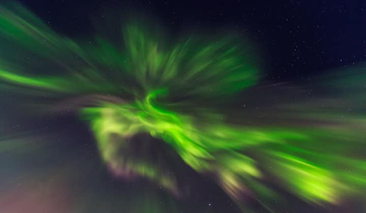A swirl of northern lights illuminating the skies in Iceland.