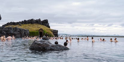 People relaxing in the geothermal waters at the Sky Lagoon spa.
