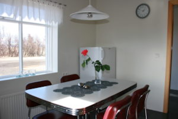 The dining table with four chairs and a refrigerator at Jadar Farm.