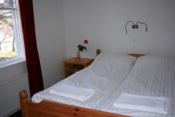 A double bed in one of the bedrooms at Jadar Farm.