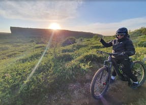 A person on an e-bike tour in North Iceland puts their thumb up to the camera.
