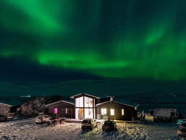 The beautiful northern lights dances above the Aurora Lodge Hotel.