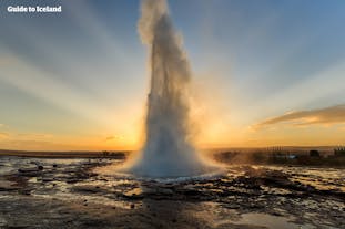 The Strokkur geyser in the Golden Circle erupting at sunset.