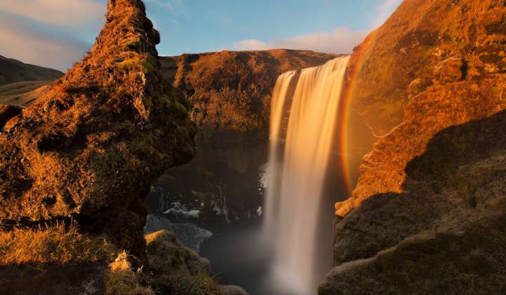 In the summer glow of the sun, a rainbow is constantly present in the mist from Skógafoss waterfall.