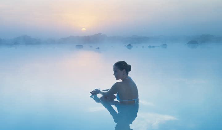 A woman relaxing in the Blue Lagoon geothermal spa in Iceland.
