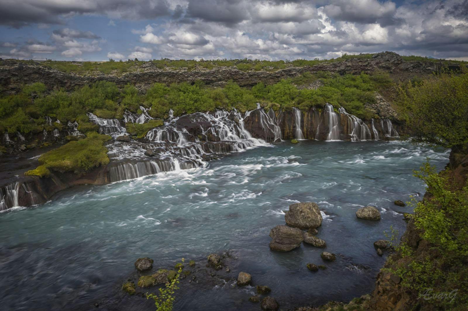 Hraunfossar waterfall streams out of a wide lava field in east Iceland in many serene rivulets.