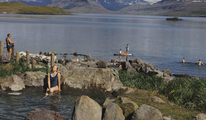 Guests enjoying a geothermal bath at Hvammsvik hot springs in West Iceland.