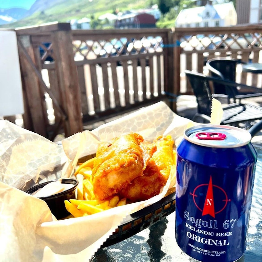 A can of Segull 67 beer, Siglufjordur's local brewery, goes down nicely with fish and chips.