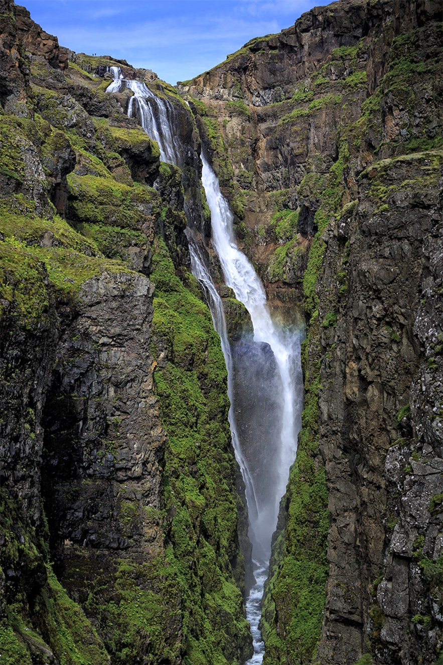The waterfall Glymur 196m high. If you look well then you can see two standing at the top